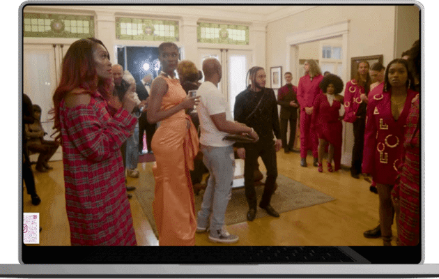 A woman stands confidently in front of a group of attentive people engaging them with her presentation