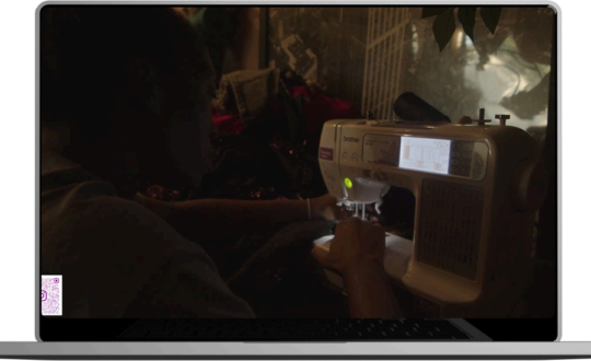 A man sewing a garment on a machine.