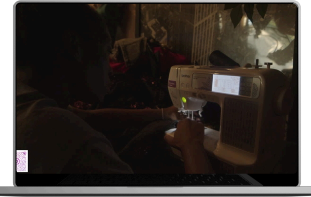 A man sewing a garment on a machine.